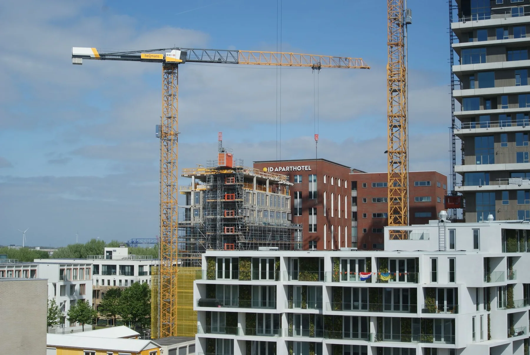 Tower cranes beside multi-story buildings under construction