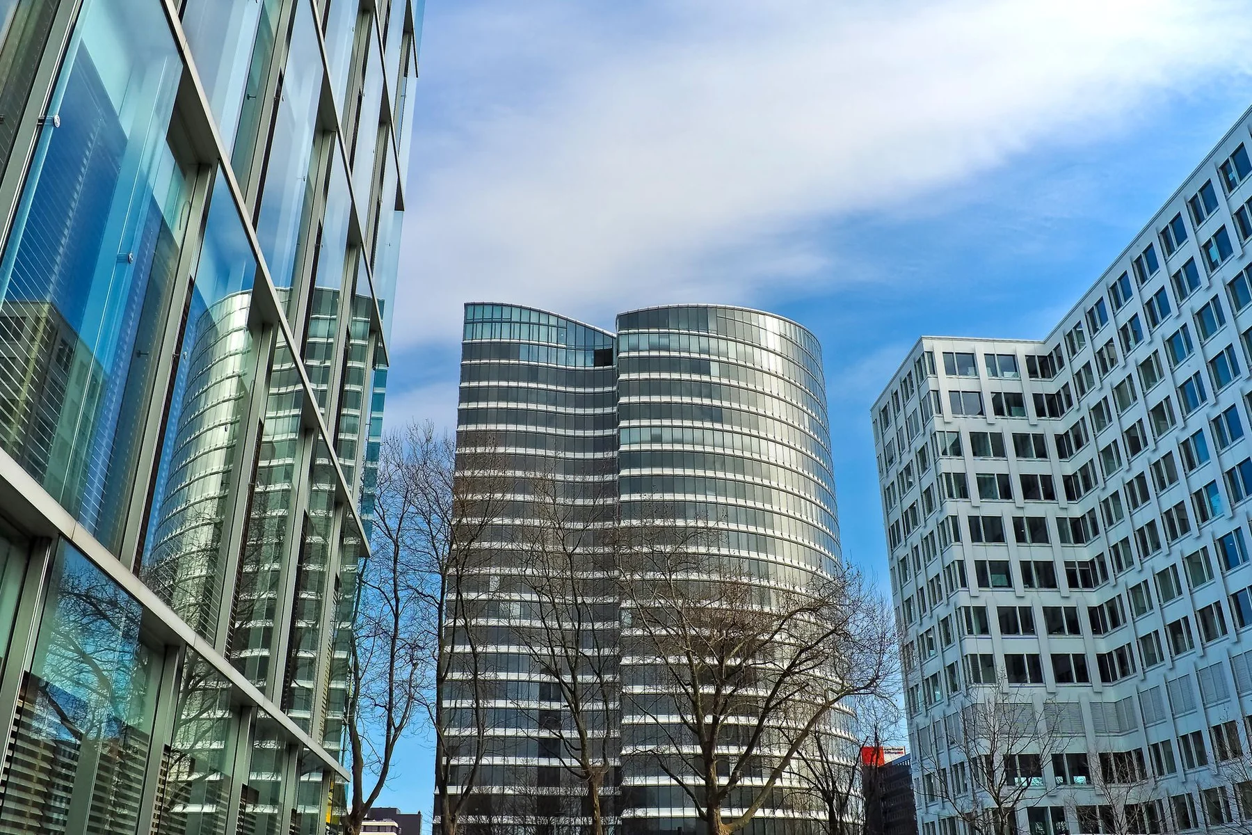 Modern glass office towers surrounding a business plaza